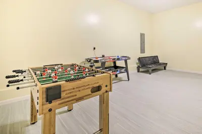 a room with a foosball table and a table with at 3 Mi to Kalahari Pocono Summit Home with Game Room! in Pocono Summit