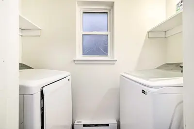 a white laundry room with a washer and a window at 3 Mi to Kalahari Pocono Summit Home with Game Room! in Pocono Summit