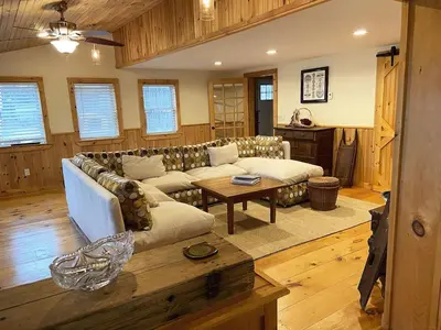 a living room with a couch and a table at FRENCH WOODS FARMHOUSE Catskills Upper Delaware River Hancock NY in Hancock