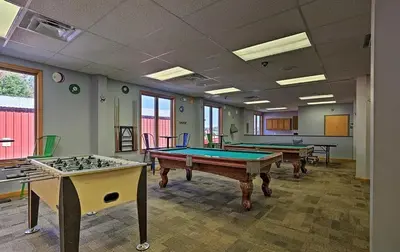 a room with two pool tables in it with windows at Lakefront Cabin Pvt Beach and Dock - Sunset Marina in Arrowhead Lake