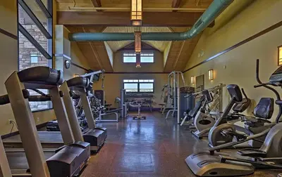 a gym with several treadmills and cardio machines at Lakefront Cabin Pvt Beach and Dock - Sunset Marina in Arrowhead Lake