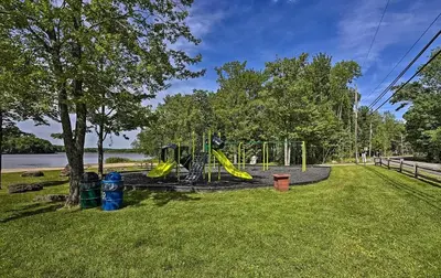 a playground with a slide in a park at Lakefront Cabin Pvt Beach and Dock - Sunset Marina in Arrowhead Lake
