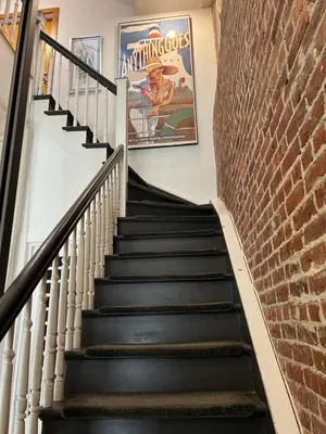 a set of stairs with a movie poster on the wall at Modern loft style 2bed 2bath minutes to Times Square in West New York