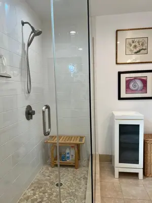 a shower with a glass door in a bathroom at Modern loft style 2bed 2bath minutes to Times Square in West New York