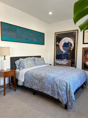 a bedroom with a bed and a table with a lamp at Modern loft style 2bed 2bath minutes to Times Square in West New York