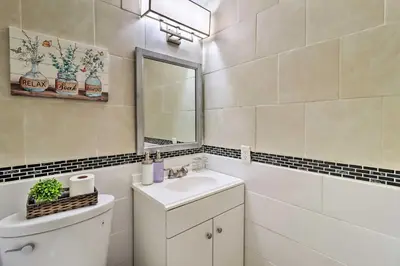 a bathroom with a sink and a mirror and a toilet at Family-Friendly Tobyhanna Home with Game Room! in Tobyhanna