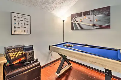 a room with a pool table in a room with avertisement at Family-Friendly Tobyhanna Home with Game Room! in Tobyhanna