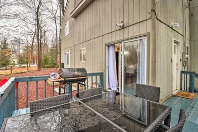 a patio with chairs and a table on a balcony at Family-Friendly Tobyhanna Home with Game Room! in Tobyhanna