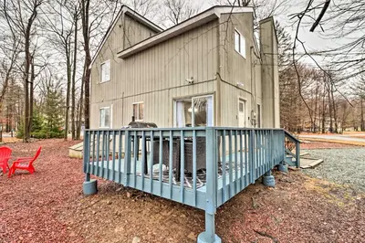 a small house with a blue porch and a red chair at Family-Friendly Tobyhanna Home with Game Room! in Tobyhanna