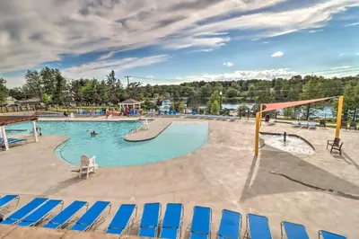 a large swimming pool with chairs and a playground at Family-Friendly Tobyhanna Home with Game Room! in Tobyhanna