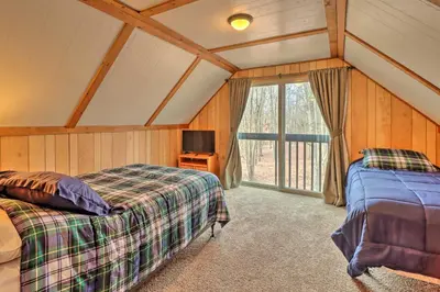 a bedroom with two beds in a room with a window at Lake Harmony Access Home with Game Room and Fire Pit! in Lake Harmony