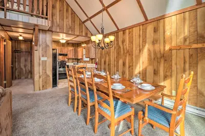 a dining room with a wooden table and chairs at Lake Harmony Access Home with Game Room and Fire Pit! in Lake Harmony