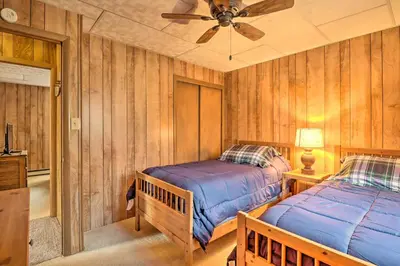 a bedroom with two beds and a ceiling fan at Lake Harmony Access Home with Game Room and Fire Pit! in Lake Harmony