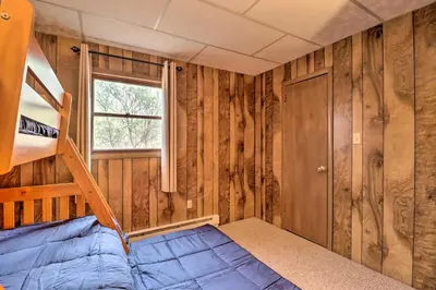 a bedroom with a bunk bed and a window at Lake Harmony Access Home with Game Room and Fire Pit! in Lake Harmony