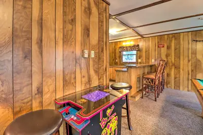 a ping pong table in a room with wooden walls at Lake Harmony Access Home with Game Room and Fire Pit! in Lake Harmony