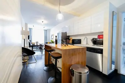 a kitchen with a wooden island in a room at E10-1 Designer East Village Townhouse 1BR in New York