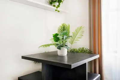 a table with a potted plant on top of it at 428-2W Newly Furnished Prime Location 2BR Sleeps 5 in New York