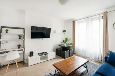 a living room with a blue couch and a tv at 428-2W Newly Furnished Prime Location 2BR Sleeps 5 in New York