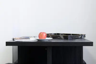 an apple sitting on a table with a plate at 428-2W Newly Furnished Prime Location 2BR Sleeps 5 in New York