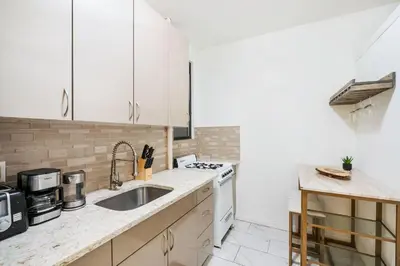 a kitchen with white cabinets and a sink at 428-2W Newly Furnished Prime Location 2BR Sleeps 5 in New York