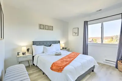 a white bedroom with a large bed and a window at Hike, Ski and Golf Mtn-View Codo in Vernon Township in Vernon Township