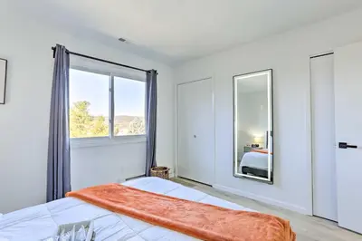 a bedroom with a bed and a large window at Hike, Ski and Golf Mtn-View Codo in Vernon Township in Vernon Township