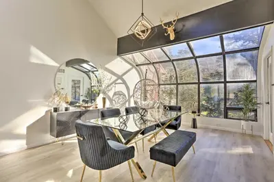 a dining room with a glass table and chairs and a large window at Hike, Ski and Golf Mtn-View Codo in Vernon Township in Vernon Township