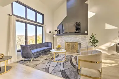 a living room with a couch and a fireplace at Hike, Ski and Golf Mtn-View Codo in Vernon Township in Vernon Township