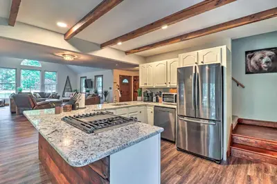 a kitchen with a stainless steel refrigerator and a living room at Hot Tub, Beach Access Albrightsville Retreat! in Albrightsville