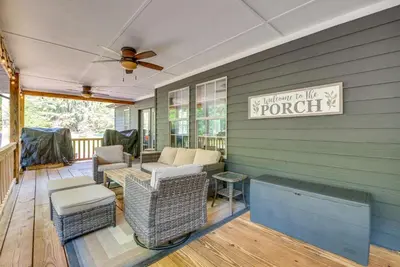 a porch with furniture and a ceiling fan at Hot Tub, Beach Access Albrightsville Retreat! in Albrightsville