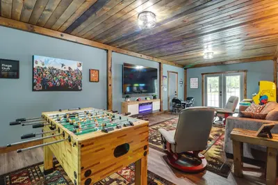 a living room with a foosball table at Hot Tub, Beach Access Albrightsville Retreat! in Albrightsville