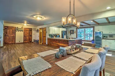 a living room with a table and a kitchen at Hot Tub, Beach Access Albrightsville Retreat! in Albrightsville