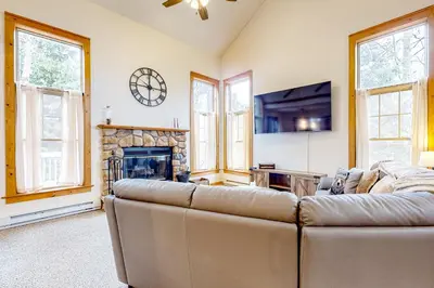 a living room with a couch and a fireplace at Casa Lontano in Tannersville