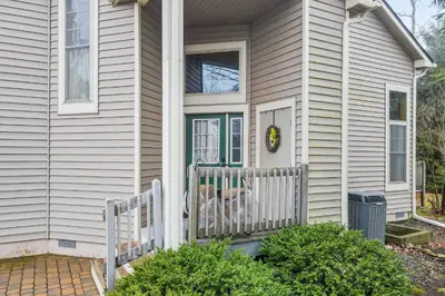 a house with a porch with a dog on the front door at Casa Lontano in Tannersville