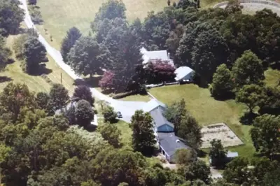 an aerial view of a house with a driveway and trees at Private Lakeview Cottage and 2 Farmhouse Apartments near Rt 80 easy to NYC in Blairstown