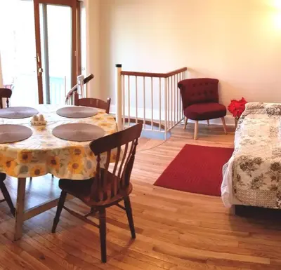 a living room with a table and chairs and a couch at Private Lakeview Cottage and 2 Farmhouse Apartments near Rt 80 easy to NYC in Blairstown
