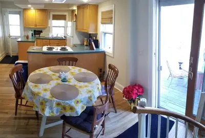 a kitchen with a table with a flowered table cloth at Private Lakeview Cottage and 2 Farmhouse Apartments near Rt 80 easy to NYC in Blairstown