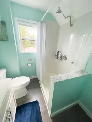 a bathroom with a white toilet and a shower at Sunny Queen bedroom feel like home!! in Englewood