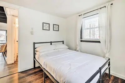 a white bedroom with a bed and a window at Pet-Friendly Cabin in Pocono Lake! in Pocono Lake