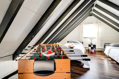 a ping pong table in the middle of a room at Pet-Friendly Cabin in Pocono Lake! in Pocono Lake