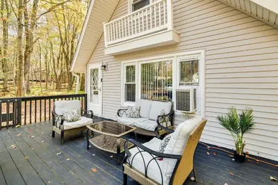 a patio with chairs and a table on a house at Pet-Friendly Cabin in Pocono Lake! in Pocono Lake