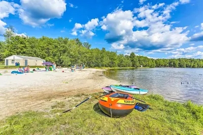 two boats sitting on the shore of a beach at Pet-Friendly Cabin in Pocono Lake! in Pocono Lake
