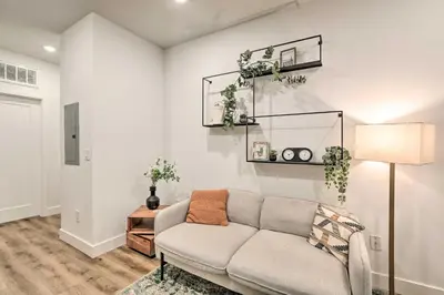 a living room with a couch and a lamp at Classy Philly Apartment 2 Mi to Downtown! in Philadelphia