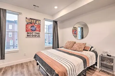a bedroom with a bed and a mirror at Classy Philly Apartment 2 Mi to Downtown! in Philadelphia