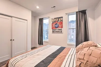 a bedroom with a bed and two windows at Classy Philly Apartment 2 Mi to Downtown! in Philadelphia