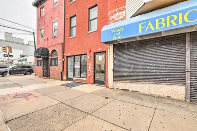a store front of a brick building with a garage at Classy Philly Apartment 2 Mi to Downtown! in Philadelphia