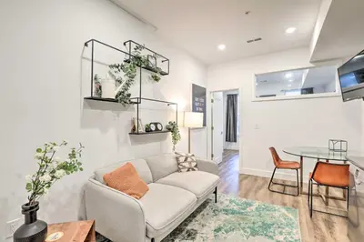 a living room with a couch and a table at Classy Philly Apartment 2 Mi to Downtown! in Philadelphia