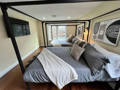 a bedroom with two beds and a large window at Cozy Cabin on the Lake w/ HotTub in Hopatcong