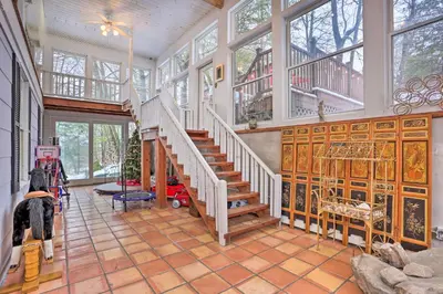 a living room with a staircase in a house at 1 Mi to Lake Wallenpaupack Spacious Poconos Villa in Hawley