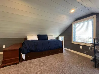 a bedroom with a bed in a attic at Calla Lily Farmhouse in Manheim